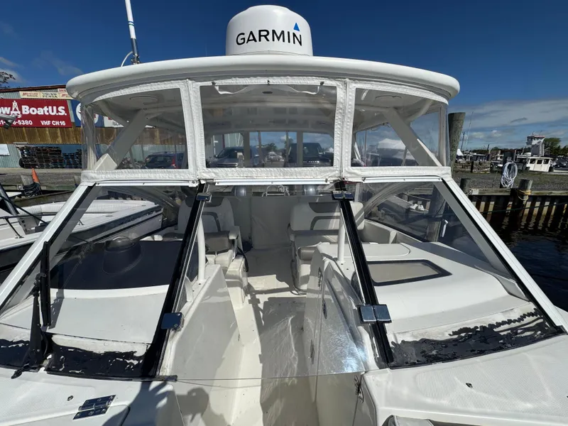 Slide: The Image of 2020 World Cat 280 DC-X boat with Garmin equipment, docked under clear blue skies. - 10