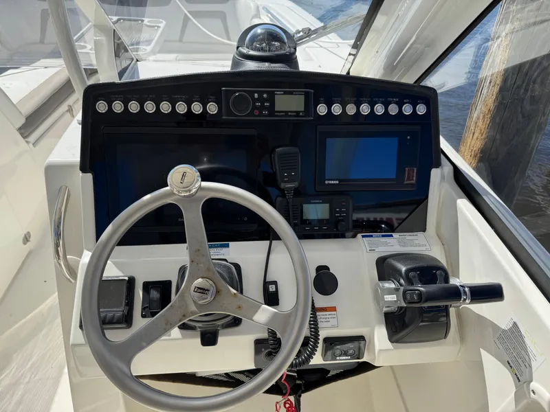 Slide: The Image of Cockpit of 2020 World Cat 280 DC-X with steering wheel and navigation controls. - 12