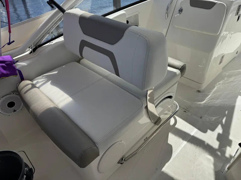 Slide: The Image of 2020 World Cat 280 DC-X boat interior seating with gray and white upholstery. - 14