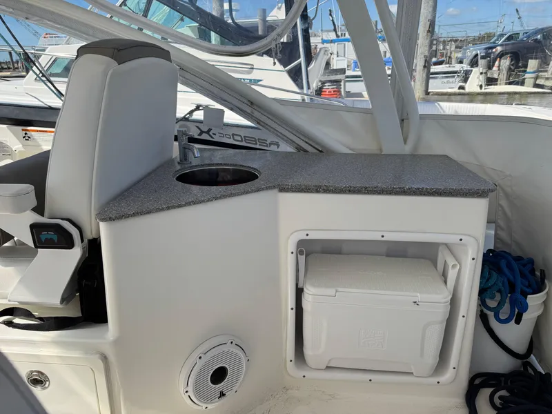 Slide: The Image of 2020 World Cat 280 DC-X boat interior with seating, storage, and cooler. - 19