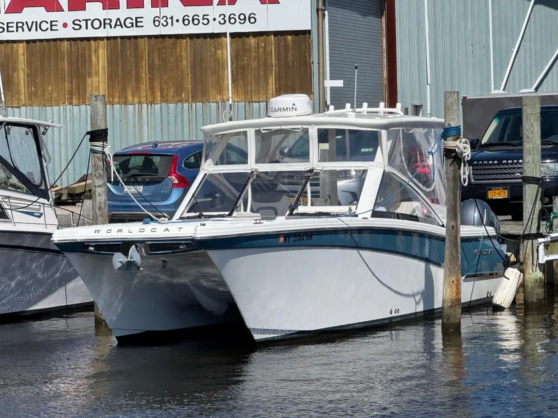 Slide: The Image of 2020 World Cat 280 DC-X boat docked at marina, front view. - 2