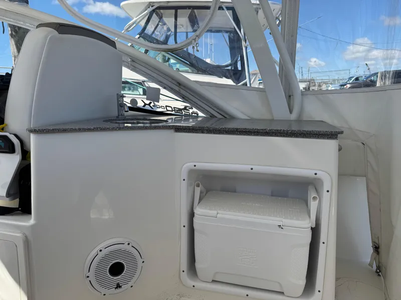 Slide: The Image of 2020 World Cat 280 DC-X boat interior with cooler and speaker. - 20