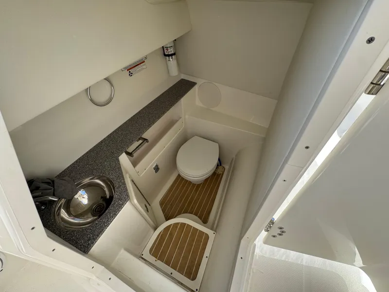 Slide: The Image of 2020 World Cat 280 DC-X boat interior bathroom with sink and toilet. - 25