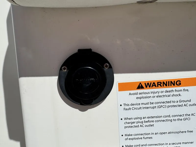 Slide: The Image of Power outlet and warning label on 2020 World Cat 280 DC-X boat. - 26
