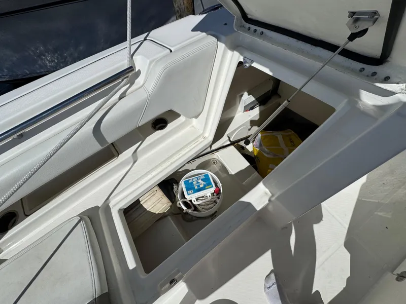 Slide: The Image of Open storage compartment on 2020 World Cat 280 DC-X boat, showing interior details. - 9