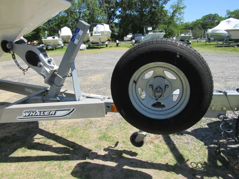 Slide: The Image of Trailer for 2013 Boston Whaler 200 Dauntless boat, parked in a marina. - 11