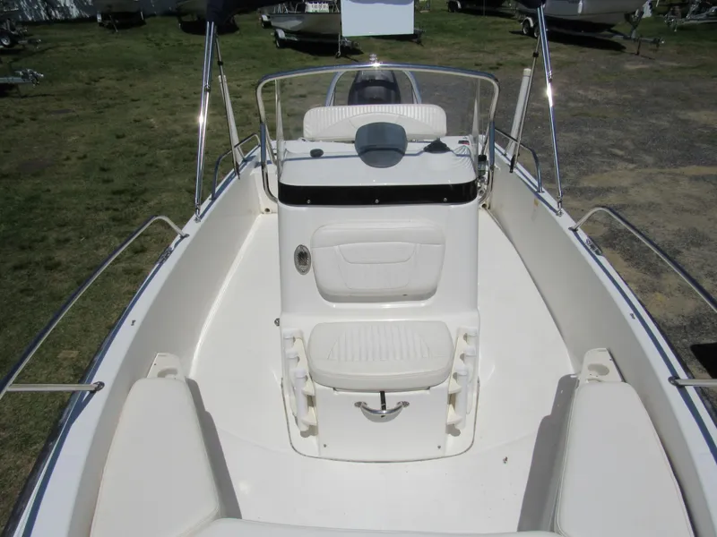 Slide: The Image of 2013 Boston Whaler 200 Dauntless boat interior with seating and console. - 13