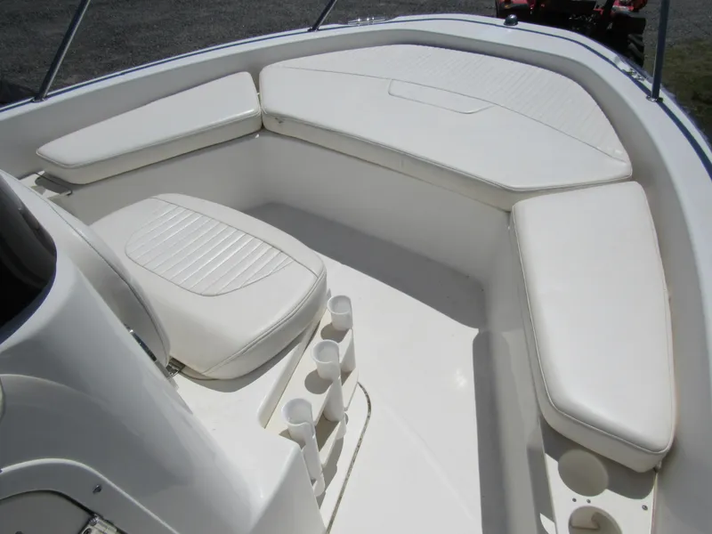 Slide: The Image of 2013 Boston Whaler 200 Dauntless boat interior with white cushioned seating. - 14