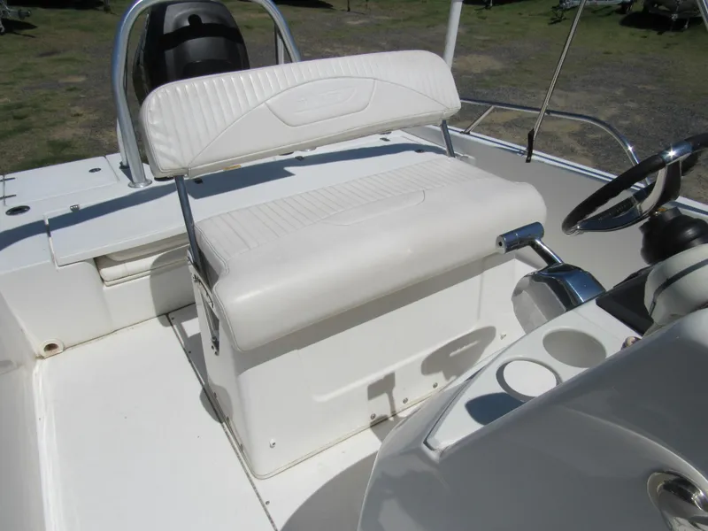 Slide: The Image of 2013 Boston Whaler 200 Dauntless boat interior with white seating and steering console. - 15