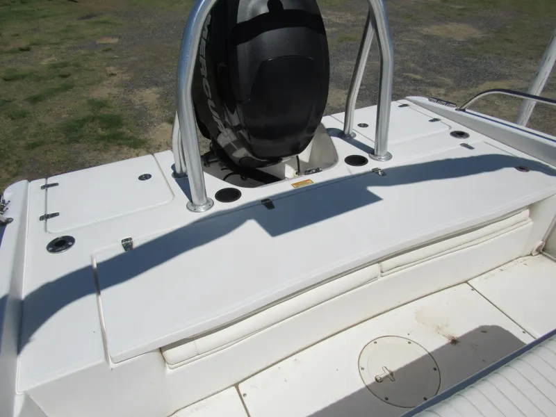 Slide: The Image of 2013 Boston Whaler 200 Dauntless boat deck with engine and seating area. - 16