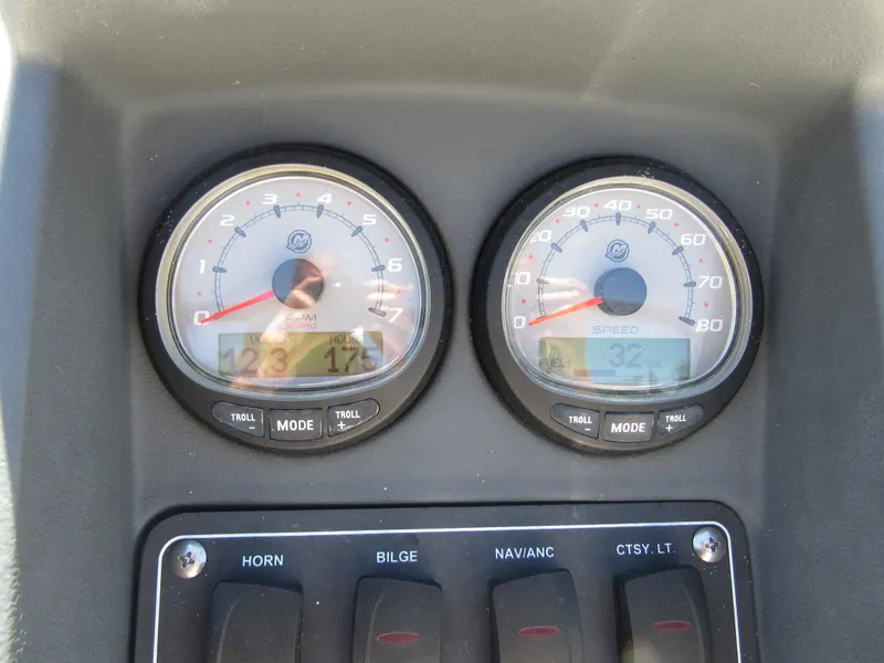 Slide: The Image of Dashboard of a 2013 Boston Whaler 200 Dauntless boat with gauges and switches. - 18