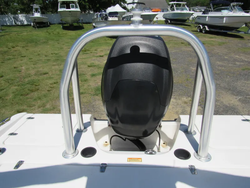 Slide: The Image of 2013 Boston Whaler 200 Dauntless boat engine and railing, with other boats in the background. - 22