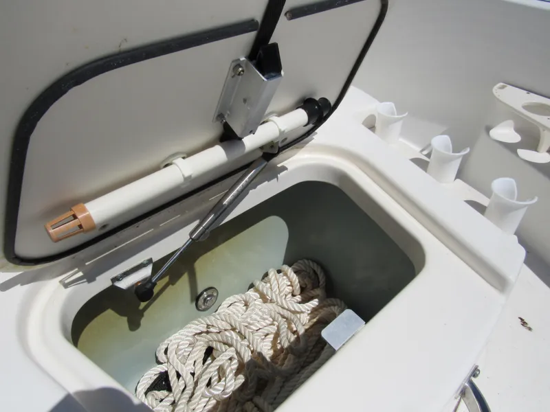 Slide: The Image of Open storage compartment with rope on a 2013 Boston Whaler 200 Dauntless boat. - 25