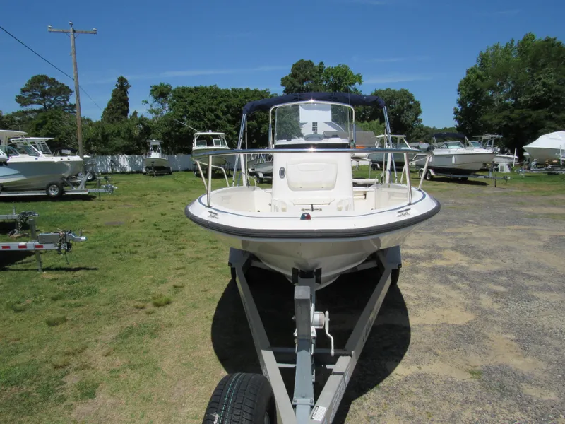Slide: The Image of 2013 Boston Whaler 200 Dauntless boat on trailer in outdoor setting. - 3