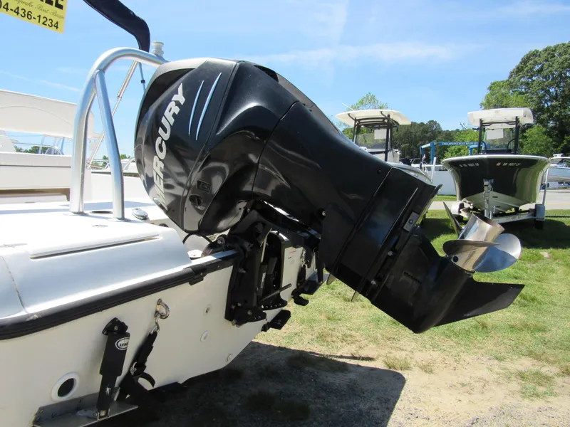Slide: The Image of 2013 Boston Whaler 200 Dauntless with Mercury outboard motor, displayed outdoors. - 7