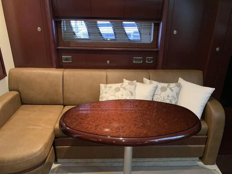 Slide: The Image of Luxurious interior of 2007 Sea Ray 40 Sundancer with elegant seating and wooden table. - 12