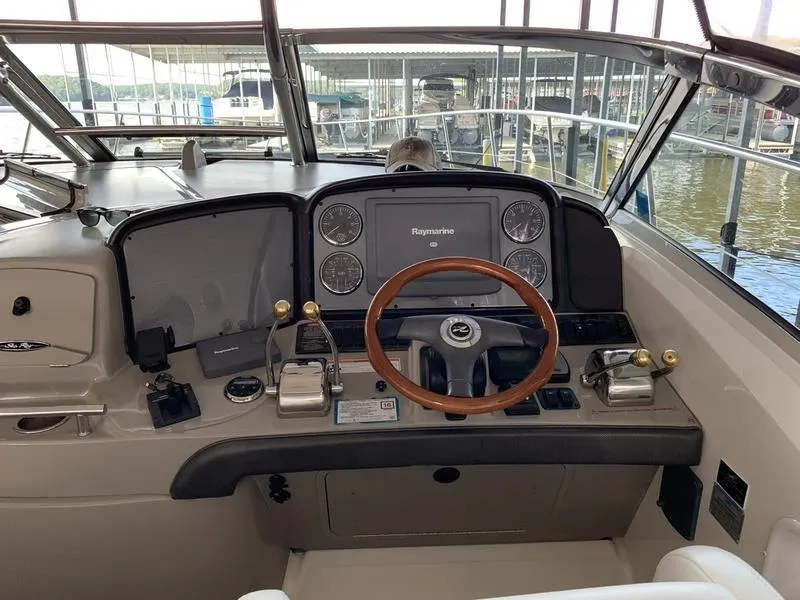 Slide: The Image of 2007 Sea Ray 40 Sundancer helm with wood steering wheel and Raymarine electronics. - 16