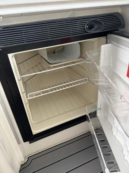 Slide: The Image of Open refrigerator on 2007 Sea Ray 40 Sundancer yacht, showing empty shelves. - 17