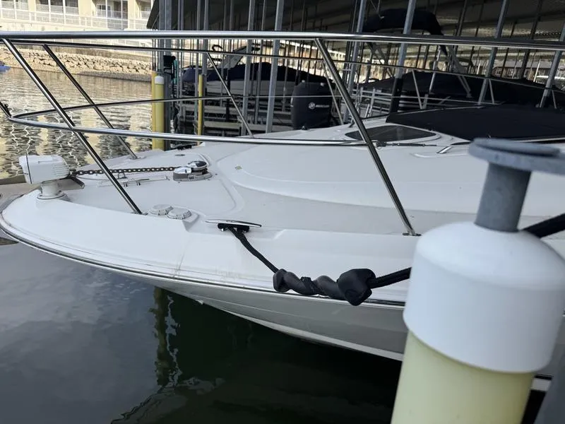 Slide: The Image of 2007 Sea Ray 40 Sundancer docked, showcasing sleek bow design and sturdy railings. - 2
