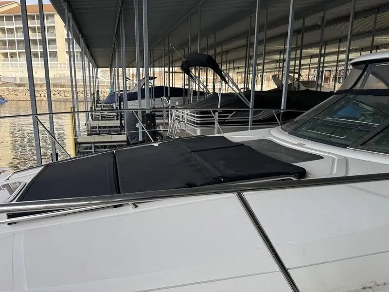 Slide: The Image of 2007 Sea Ray 40 Sundancer yacht docked in a marina under a covered shelter. - 22
