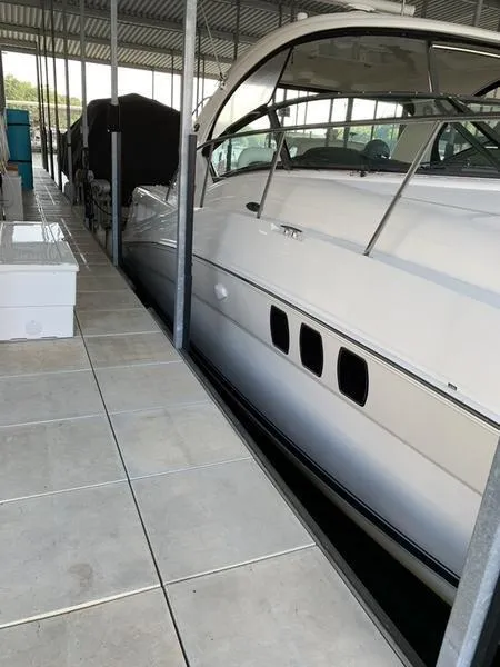 Slide: The Image of 2007 Sea Ray 40 Sundancer yacht docked in a covered marina. - 23