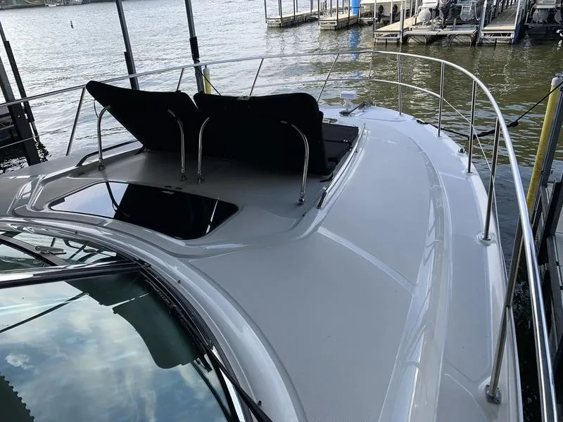 Slide: The Image of 2007 Sea Ray 40 Sundancer yacht with sun loungers on deck, docked by the water. - 3