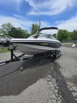 Slide: The Image of 2012 Tahoe Q8 SSi boat on trailer, parked outdoors under a partly cloudy sky. - 43