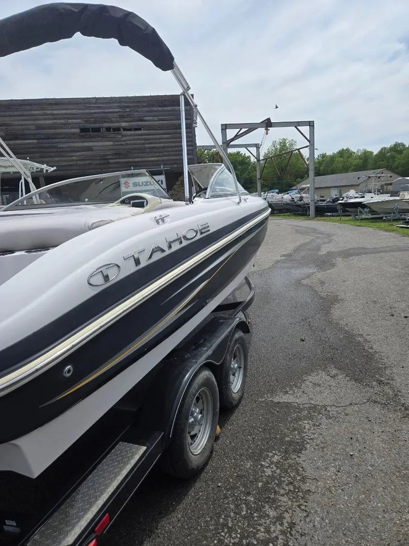 Slide: The Image of 2012 Tahoe Q8 SSi boat on trailer in outdoor setting. - 45