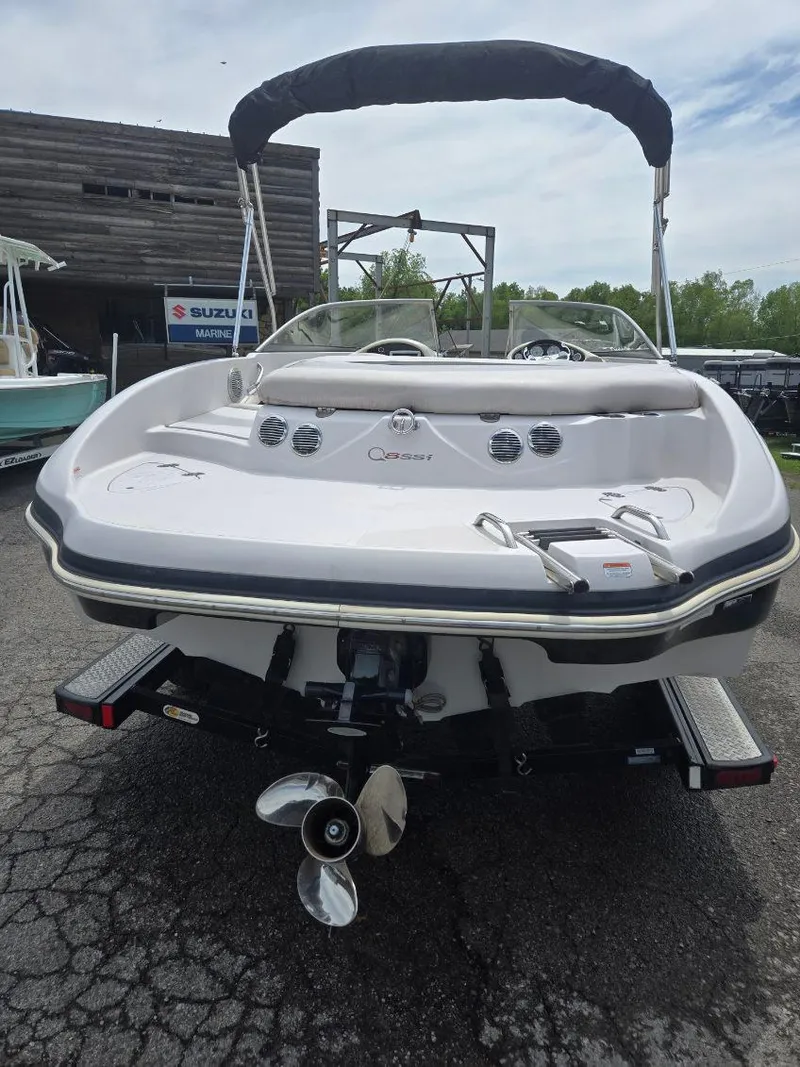 Slide: The Image of 2012 Tahoe Q8 SSi boat, rear view, parked outdoors with canopy. - 46