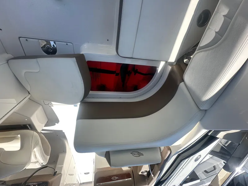 Slide: The Image of Interior view of a 2014 Chaparral 307 SSX boat, featuring sleek seating and modern design. - 10