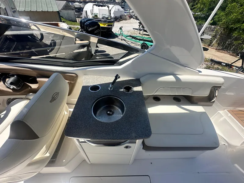 Slide: The Image of 2014 Chaparral 307 SSX boat interior with sink and seating area. - 11