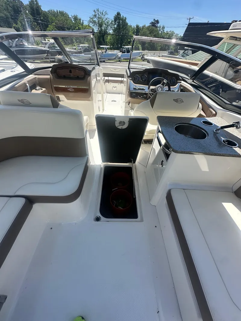 Slide: The Image of 2014 Chaparral 307 SSX boat interior with seating, helm, and kitchenette. - 12