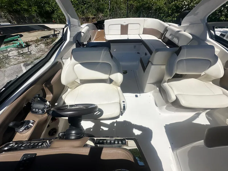 Slide: The Image of 2014 Chaparral 307 SSX boat interior with white seating and steering wheel. - 16