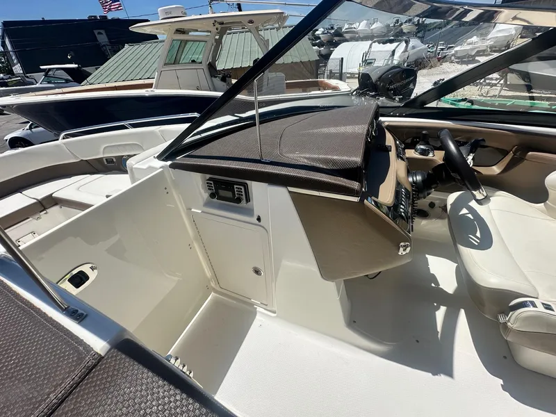Slide: The Image of 2014 Chaparral 307 SSX boat interior with steering wheel and dashboard. - 18