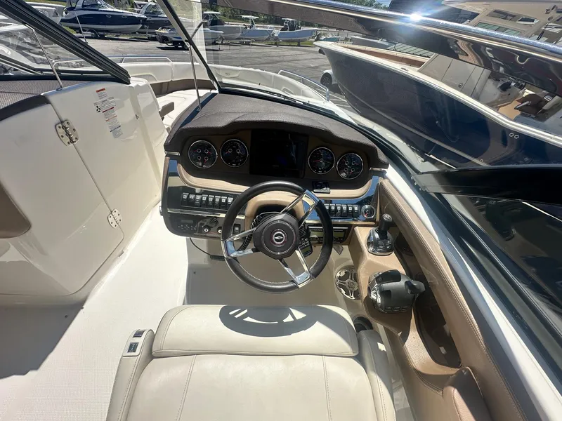 Slide: The Image of 2014 Chaparral 307 SSX boat cockpit with steering wheel and control panel. - 19