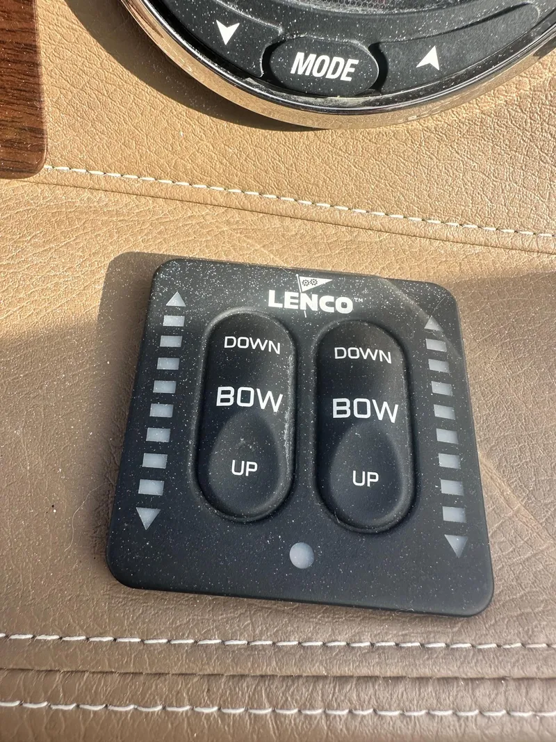 Slide: The Image of Lenco trim tab control panel on 2014 Chaparral 307 SSX boat dashboard. - 21