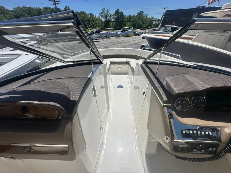 Slide: The Image of 2014 Chaparral 307 SSX boat interior with dashboard and seating area. - 23