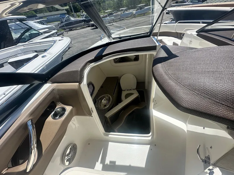 Slide: The Image of 2014 Chaparral 307 SSX boat interior with seating and storage area. - 26