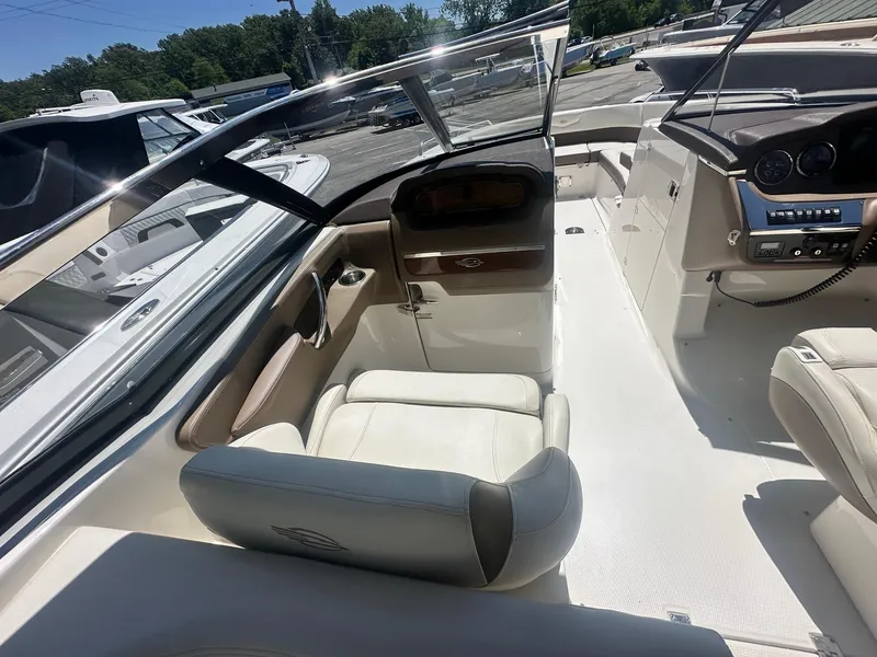 Slide: The Image of 2014 Chaparral 307 SSX boat interior with white seating and dashboard view. - 27