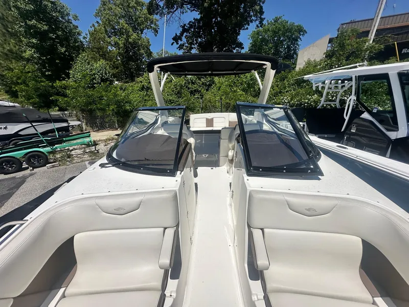 Slide: The Image of 2014 Chaparral 307 SSX boat with open cockpit and seating, surrounded by trees. - 29