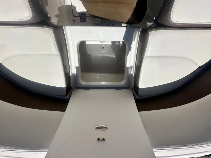 Slide: The Image of 2014 Chaparral 307 SSX boat interior with storage compartment and seating area. - 30