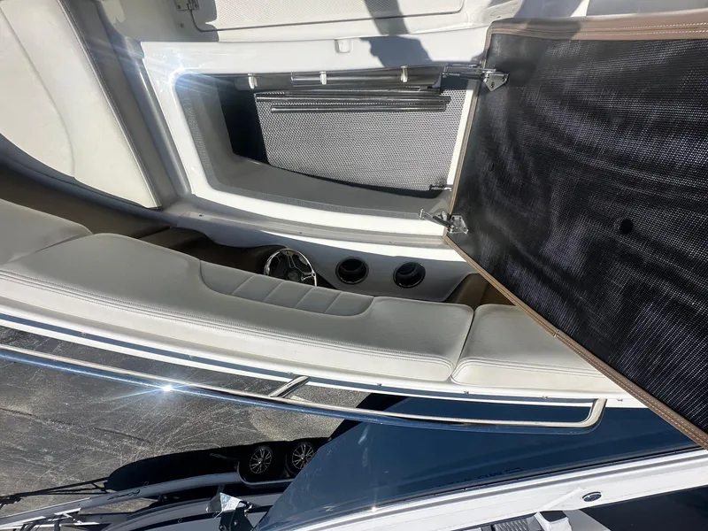 Slide: The Image of 2014 Chaparral 307 SSX boat interior with seating and storage compartment. - 31
