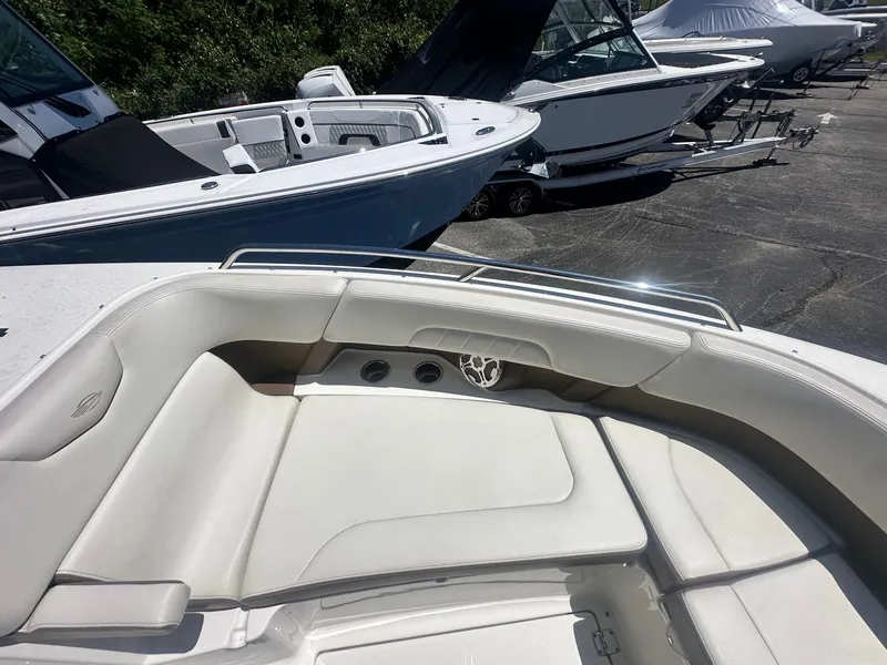 Slide: The Image of 2014 Chaparral 307 SSX boat with spacious seating, docked alongside other boats. - 32