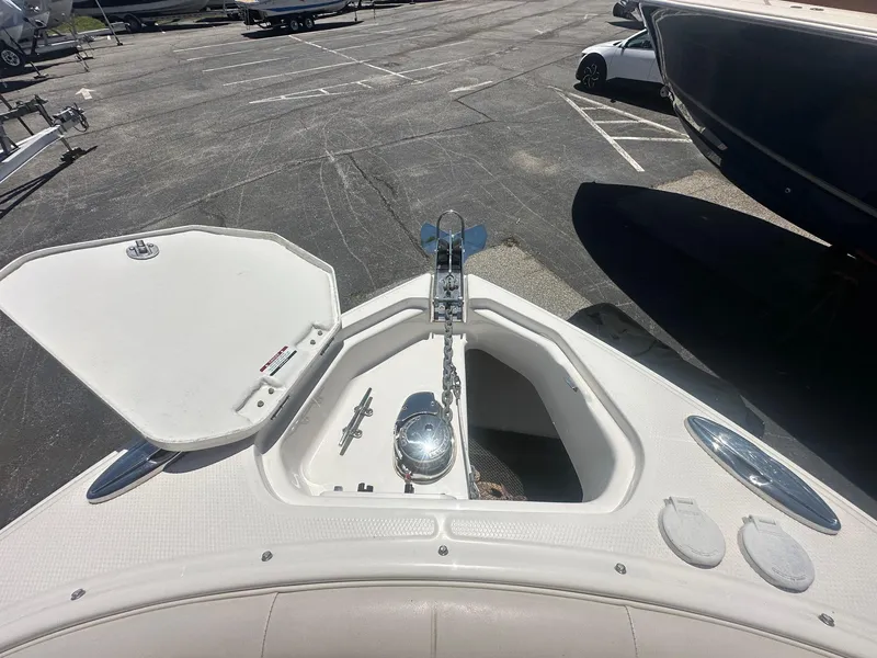 Slide: The Image of 2014 Chaparral 307 SSX boat anchor compartment in a parking lot. - 33