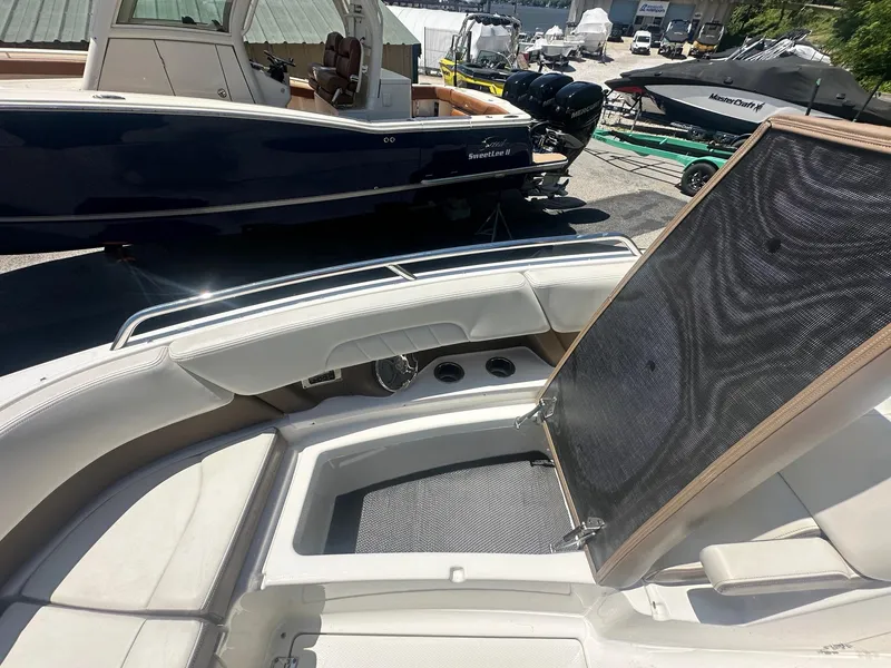 Slide: The Image of 2014 Chaparral 307 SSX boat interior with seating and open storage compartment. - 36