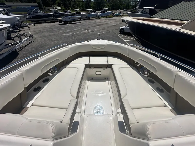 Slide: The Image of 2014 Chaparral 307 SSX boat with spacious seating in a marina setting. - 38
