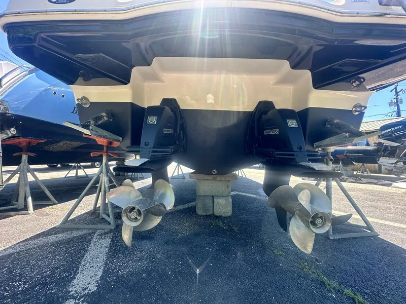 Slide: The Image of 2014 Chaparral 307 SSX boat with dual propellers, displayed on stands. - 6