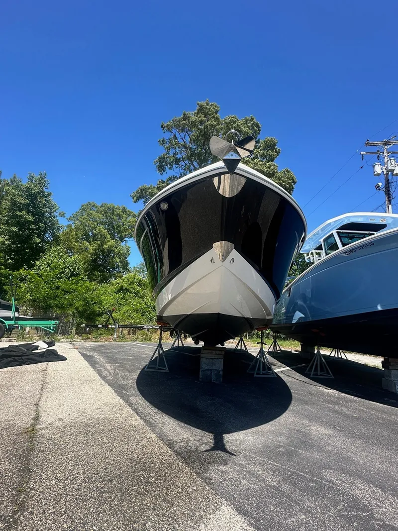 Slide: The Image of 2014 Chaparral 307 SSX boat on dry dock under clear blue sky. - 7