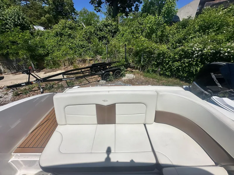 Slide: The Image of 2014 Chaparral 307 SSX boat interior with white seating and wooden accents. - 9