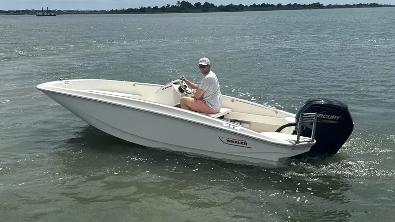 Slide: The Image of 2023 Boston Whaler 160 Super Sport boat cruising on open water. - 1